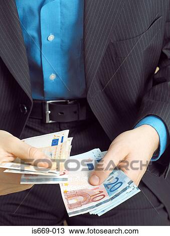 Stock Image - Businessman counting Euro notes. Fotosearch