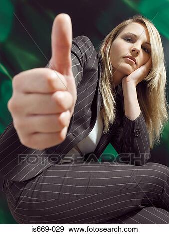 Stock Photo - Businesswoman giving thumbs up. Fotosearch