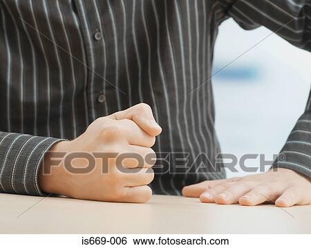 Stock Photograph - Man banging his fist on table. Fotosearch