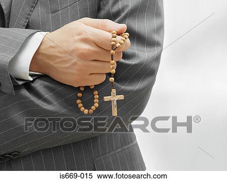 Man holding rosary beads View Large Photo Image Stock Photography - Man holding rosary beads. Fotosearch