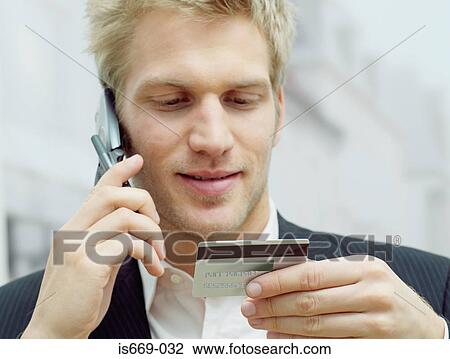 Man on mobile with credit card View Large Photo Image Stock Image - Man on mobile with credit card. Fotosearch