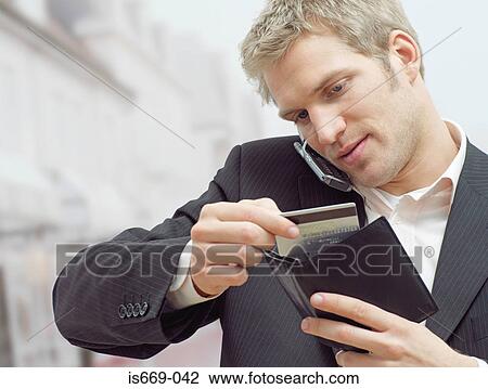 Man on mobile with credit card View Large Photo Image Stock Image - Man on mobile with credit card. Fotosearch
