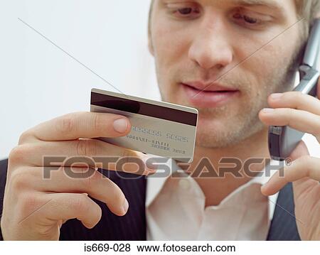 Man on mobile with credit card View Large Photo Image Stock Photo - Man on mobile with credit card. Fotosearch