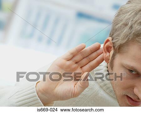 Man putting his hand to his ear View Large Photo Image Picture - Man putting his hand to his ear. Fotosearch