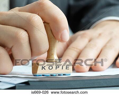 Stock Photograph - Man using a copy stamp. Fotosearch