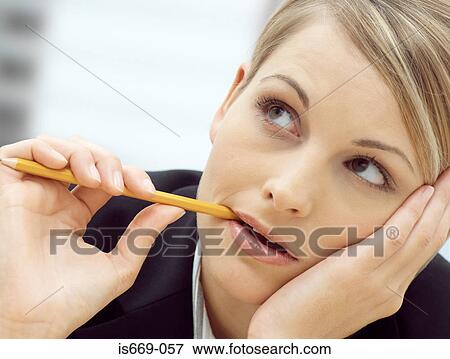 Woman chewing a pencil View Large Photo Image Stock Photo - Woman chewing a pencil. Fotosearch