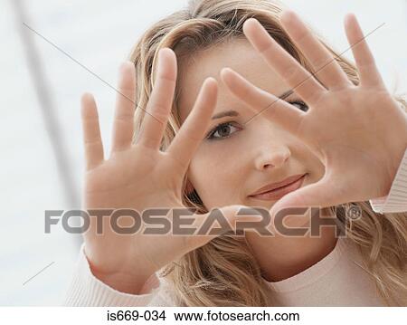 Woman making triangle shape with her hands View Large Photo Image Picture - Woman making triangle shape with her hands. Fotosearch