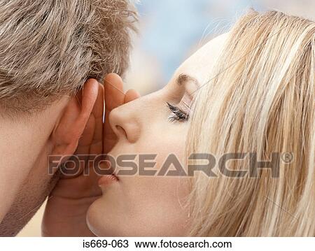 Woman whispering in man's ear View Large Photo Image Stock Image - Woman whispering in man's ear. Fotosearch