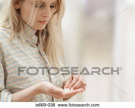 Woman with handful of drugs View Large Photo Image Stock Photo - Woman with handful of drugs. Fotosearch