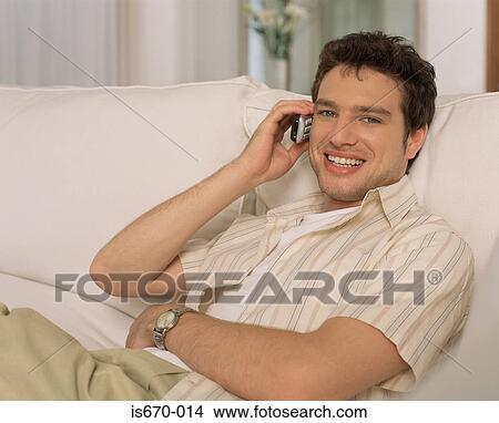 Picture - Young man on his mobile phone. Fotosearch