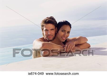 Couple at the edge of swimming pool View Large Photo Image Stock Photo - Couple at the edge of swimming pool. Fotosearch