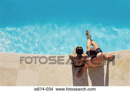 Picture - Couple by the swimming pool. Fotosearch