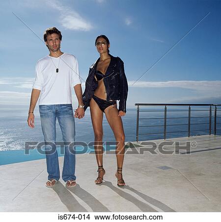 Couple holding hands by the pool View Large Photo Image Picture - Couple holding hands by the pool. Fotosearch