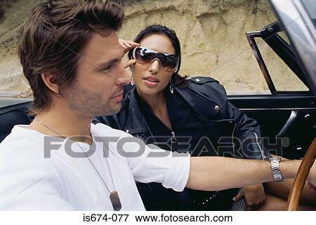 Couple in a convertible View Large Photo Image Stock Photo - Couple in a convertible. Fotosearch