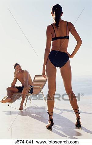 Stock Image - Man looking at sexy woman. Fotosearch