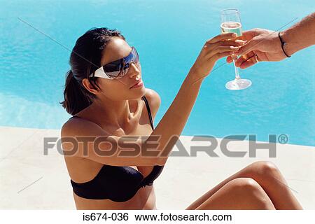 Woman being passed a champagne glass View Large Photo Image Stock Photograph - Woman being passed a champagne glass. Fotosearch