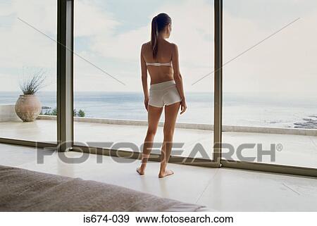 Woman looking out of french windows View Large Photo Image Stock Photo - Woman looking out of french windows. Fotosearch