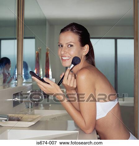 Woman putting on makeup View Large Photo Image Stock Photo - Woman putting on makeup. Fotosearch