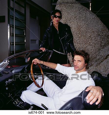 Stock Image - Young couple with vintage car. Fotosearch