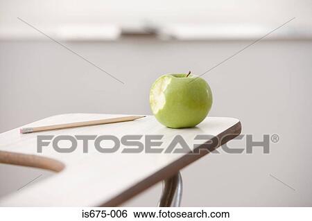 Apple and pencil on a desk View Large Photo Image Stock Photograph - Apple and pencil on a desk. Fotosearch