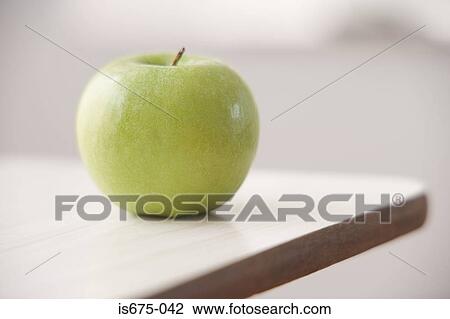 Stock Image - Apple on a desk. Fotosearch
