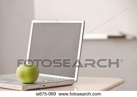 Apple on a laptop computer View Large Photo Image Stock Photo - Apple on a laptop computer. Fotosearch