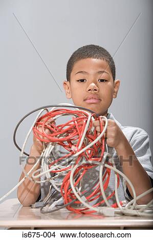 Boy holding electrical cables View Large Photo Image Picture - Boy holding electrical cables. Fotosearch