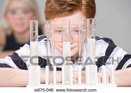 Stock Photograph - Boy looking at test tubes. Fotosearch