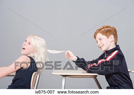 Stock Photo - Boy pulling girl's hair. Fotosearch