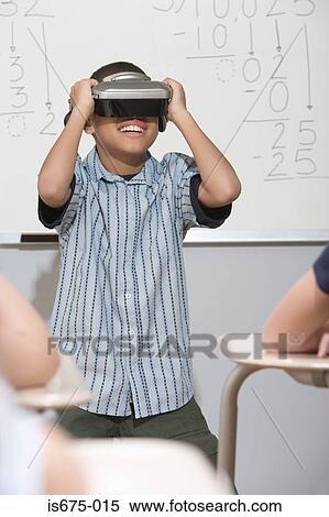 Boy wearing virtual reality headset View Large Photo Image Stock Photography - Boy wearing virtual reality headset. Fotosearch