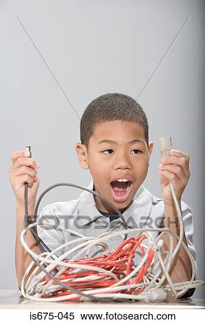 Boy with tangled cables View Large Photo Image Stock Photography - Boy with tangled cables. Fotosearch