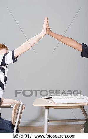 Boys doing a high five View Large Photo Image Stock Photo - Boys doing a high five. Fotosearch
