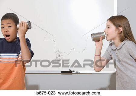 Stock Image - Children using tin can phone. Fotosearch