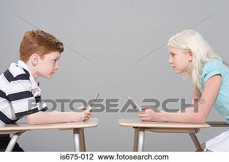 Girl and boy with mobile phones View Large Photo Image Stock Image - Girl and boy with mobile phones. Fotosearch