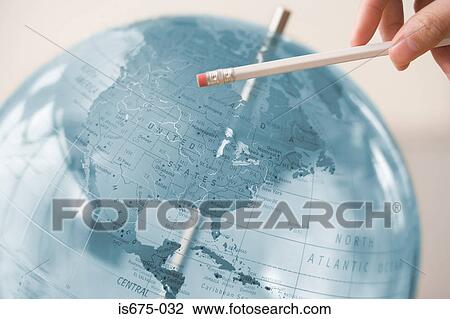 Person pointing at a globe with a pencil View Large Photo Image Stock Image - Person pointing at a globe with a pencil. Fotosearch