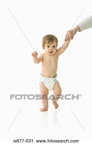 Stock Image - Adult helping baby to walk. Fotosearch