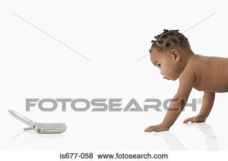 Stock Photo - Baby crawling towards mobile phone. Fotosearch
