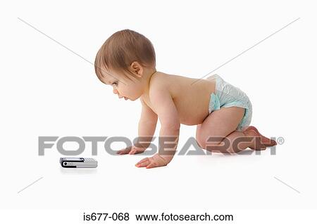 Stock Photo - Baby crawling towards mobile phone. Fotosearch