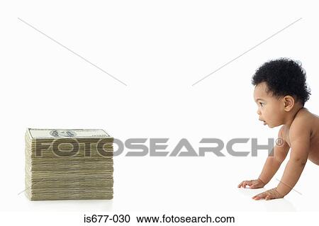 Stock Image - Baby crawling towards pile of money. Fotosearch