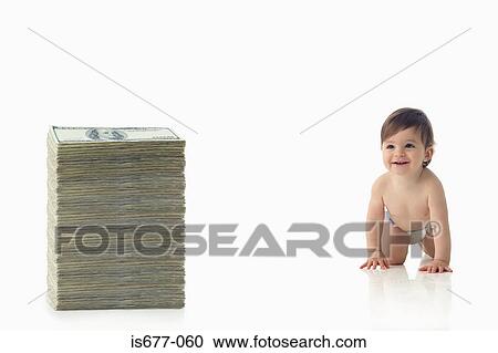 Stock Image - Baby crawling towards pile of money. Fotosearch
