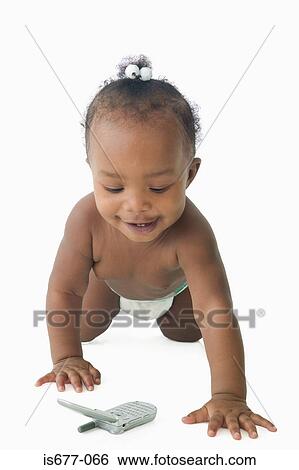 Stock Photograph - Baby girl looking at mobile phone. Fotosearch