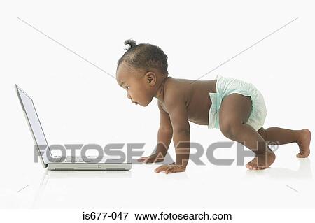 Baby looking at laptop View Large Photo Image Stock Photo - Baby looking at laptop. Fotosearch