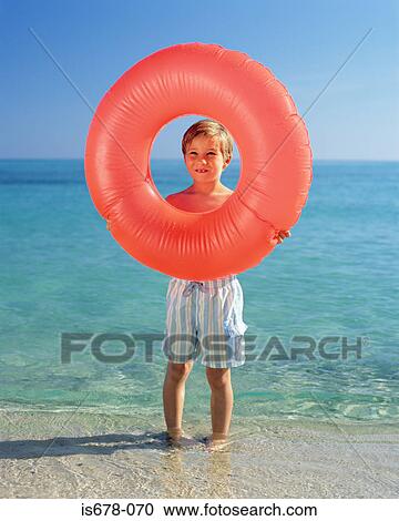 Boy holding inflatable ring View Large Photo Image Stock Image - Boy holding inflatable ring. Fotosearch