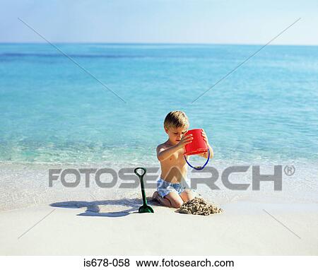 Boy playing with sand View Large Photo Image Stock Photo - Boy playing with sand. Fotosearch