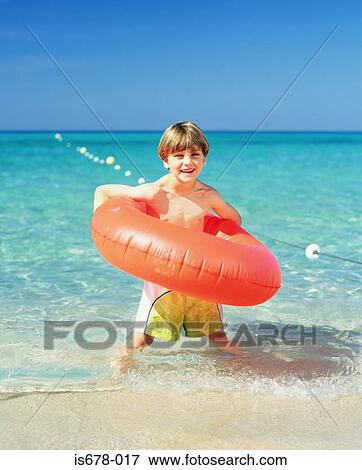 Boy with an inflatable ring View Large Photo Image Stock Photo - Boy with an inflatable ring. Fotosearch