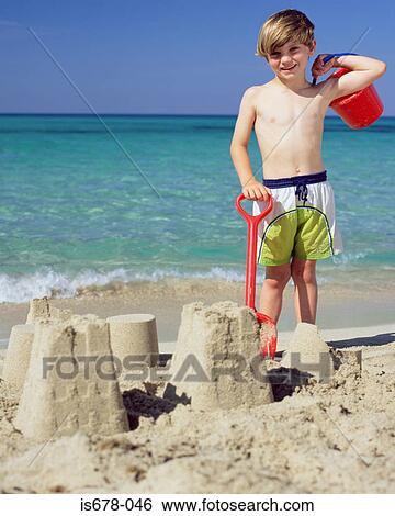 Boy with sandcastles View Large Photo Image Stock Photograph - Boy with sandcastles. Fotosearch
