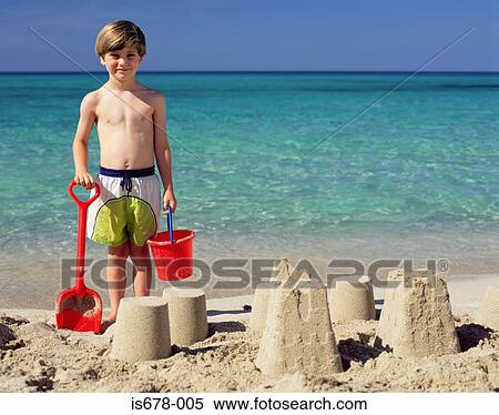 Boy with sandcastles View Large Photo Image Stock Photography - Boy with sandcastles. Fotosearch