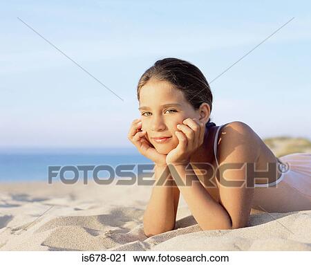 Girl lying on the sand View Large Photo Image Stock Image - Girl lying on the sand. Fotosearch