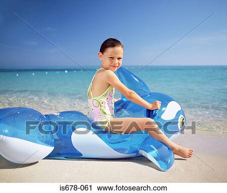 Girl on an inflatable whale View Large Photo Image Stock Image - Girl on an inflatable whale. Fotosearch