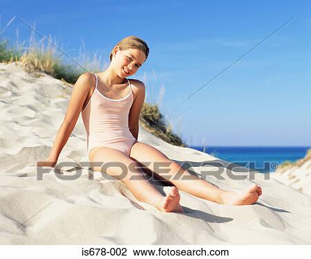 Girl sitting on a sand dune View Large Photo Image Stock Image - Girl sitting on a sand dune. Fotosearch